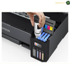 Epson EcoTank L11050 Large-Format A3 Colour Printing | L11050. An Epson printer with a hand inserting a refill cartridge into its ink tank area, shown on a white background with an Epson logo visible on the printer body.