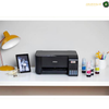 Epson EcoTank L3252 Refillable Four-Colour Ink Tank System | L3252.An Epson inkjet printer sits on a white desk alongside a yellow desk lamp, a framed picture, and several ink bottles against a light gray wall.