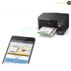 Epson EcoTank L3252 Compact Printer Side View | L3252. An Epson printer with a paper tray loaded with a colorful printout, shown alongside a smartphone displaying the Epson Smart Panel app, with a wireless signal icon between them on a white background.